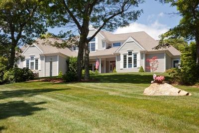 133 Cairn Ridge Road East Falmouth, MA 02536 - Photo 17 of 19 a front view of a house with a garden and trees