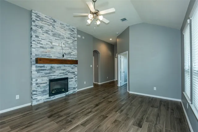 wooden floor fireplace and natural light in room