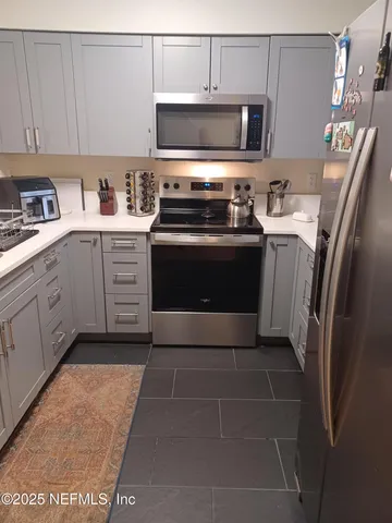 a kitchen with a refrigerator stove and sink