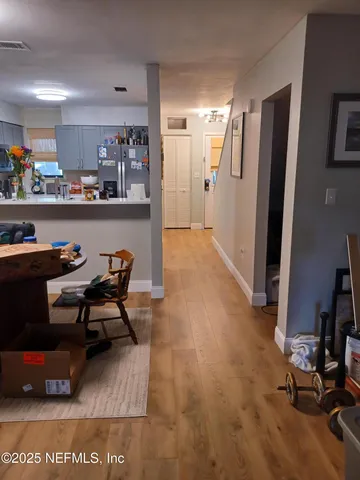 a living room with stainless steel appliances kitchen island granite countertop furniture and a view of kitchen