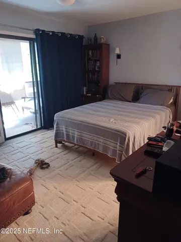 a bedroom with a bed and window