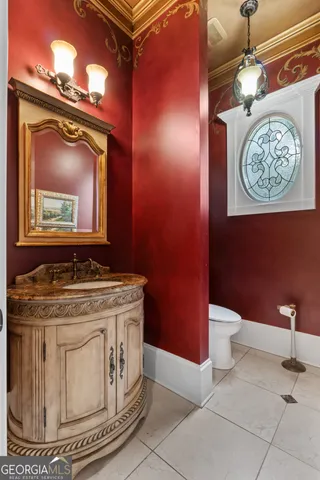 a bathroom with a double vanity sink mirror and toilet