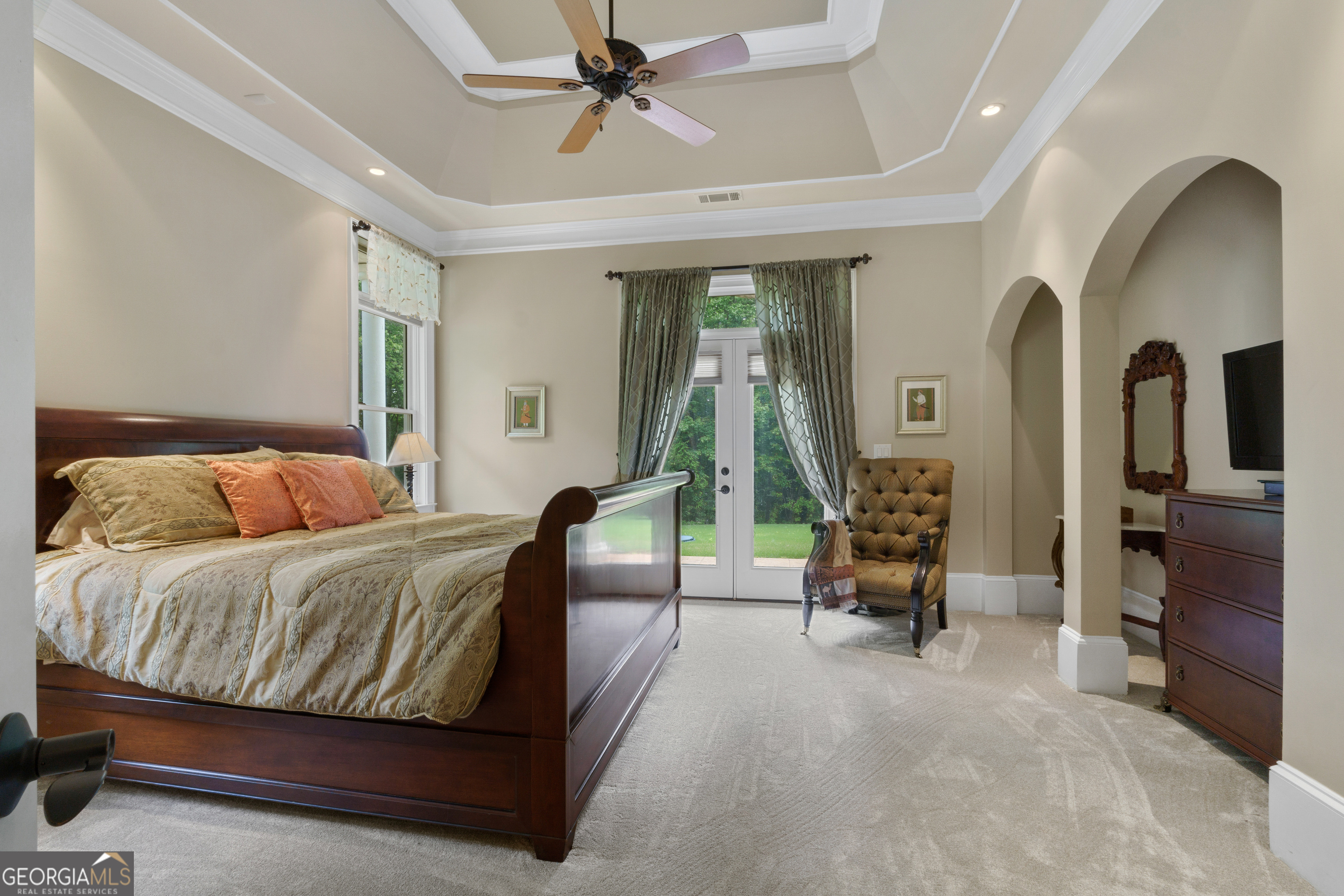 1005 Oak Mountain Road Carrollton, GA 30116 - Photo 59 of 73 a spacious bedroom with a bed a couch and a chandelier
