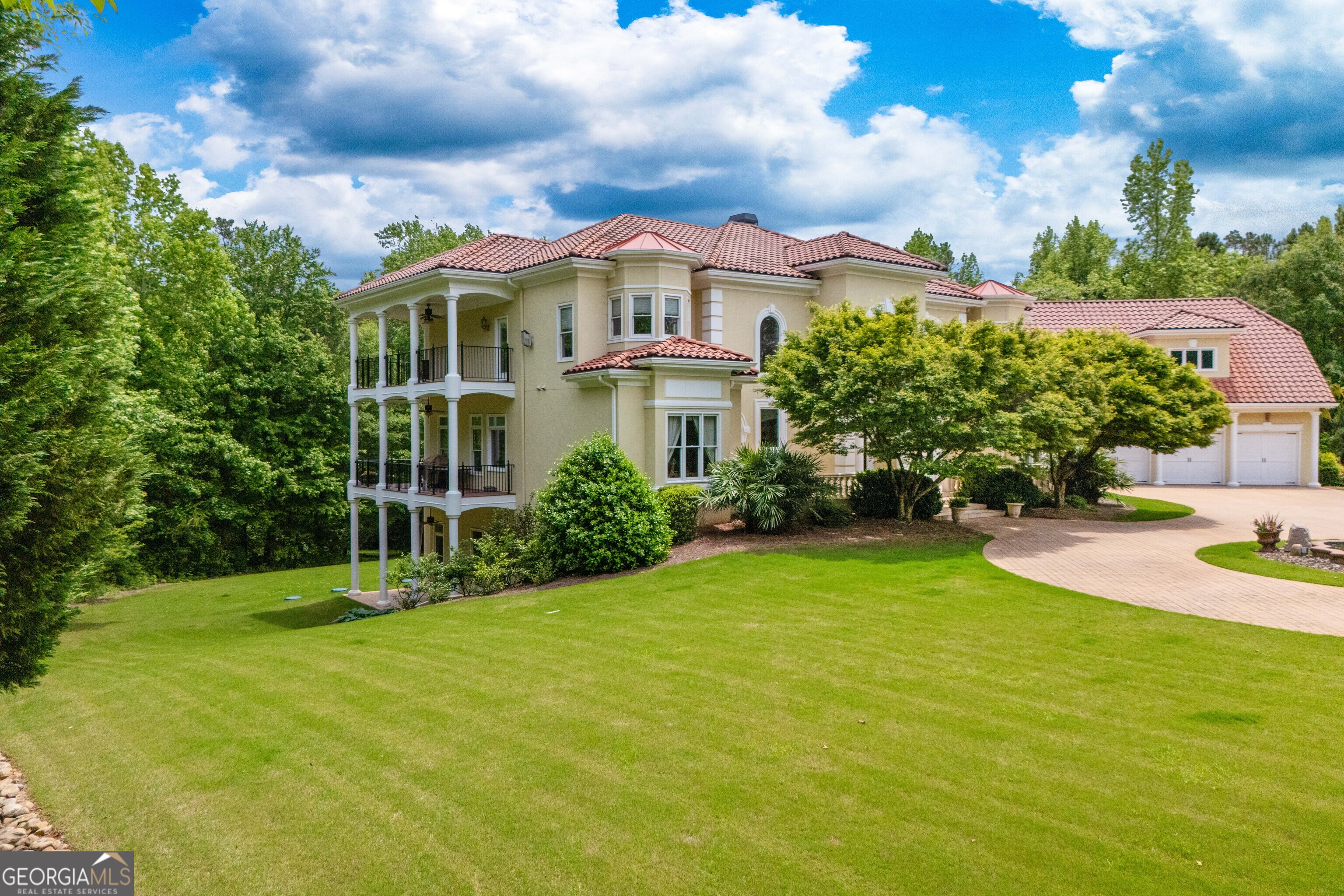 1005 Oak Mountain Road Carrollton, GA 30116 - Photo 64 of 73 a view of a white house with a big yard and potted plants