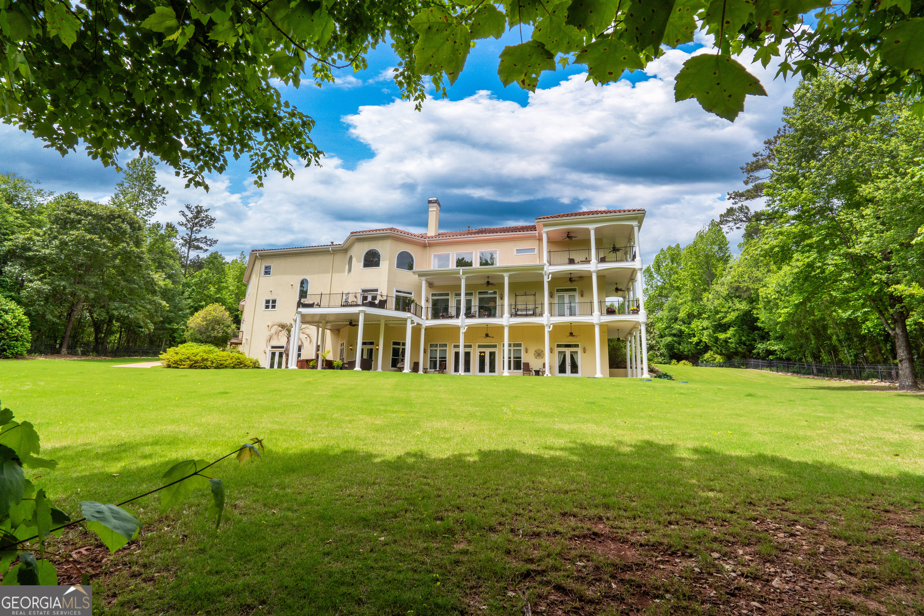 1005 Oak Mountain Road Carrollton, GA 30116 - Photo 66 of 73 a view of a big house with a big yard and large trees