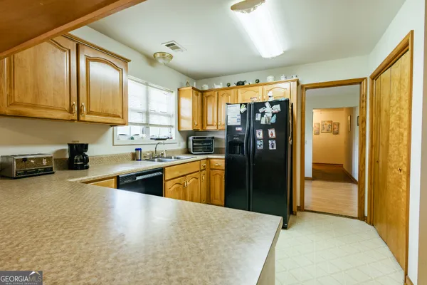 a kitchen with stainless steel appliances granite countertop a sink and cabinets