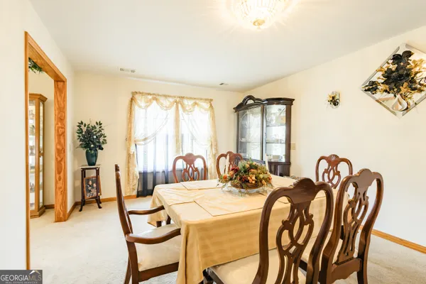a view of a dining room with furniture and window