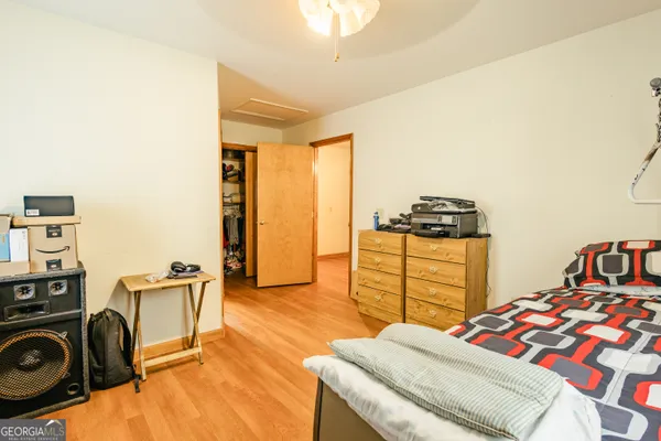 a bedroom with a bed and a small bathroom