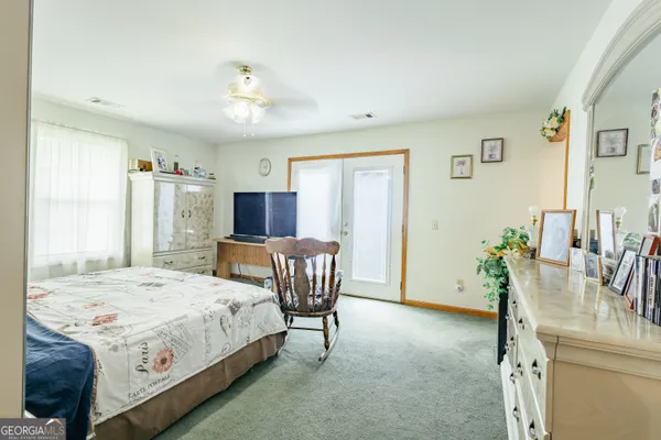 a bed room with furniture and a chair