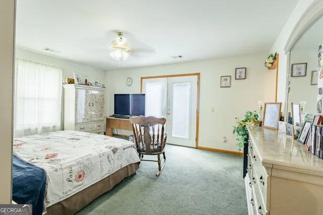 a bed room with furniture and a chair