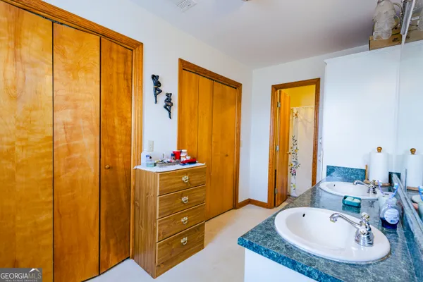 a bathroom with a double vanity sink and a mirror