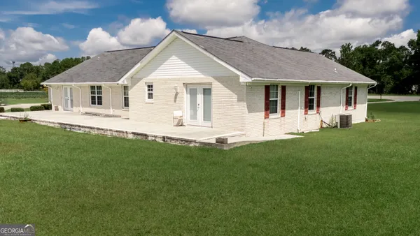 a front view of a house with a garden and yard