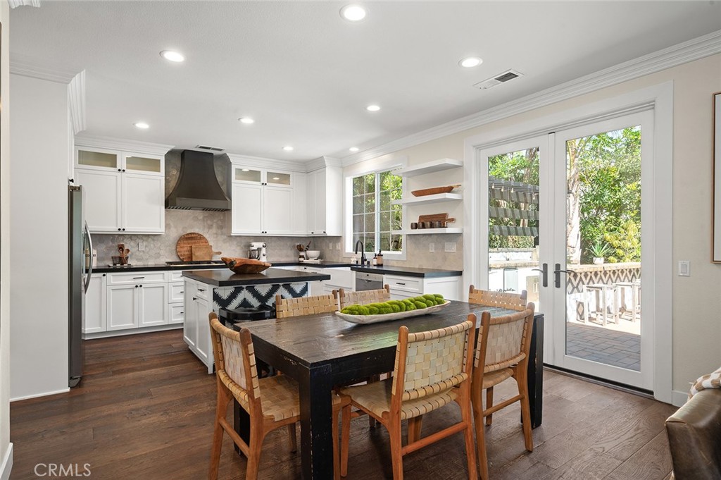 9 Baudin Circle Ladera Ranch, CA 92694 - Photo 12 of 48 a kitchen with a table chairs stove and cabinets