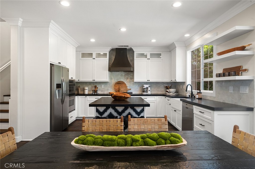 9 Baudin Circle Ladera Ranch, CA 92694 - Photo 13 of 48 a kitchen with stainless steel appliances granite countertop a sink dishwasher a refrigerator and a stove with wooden floor