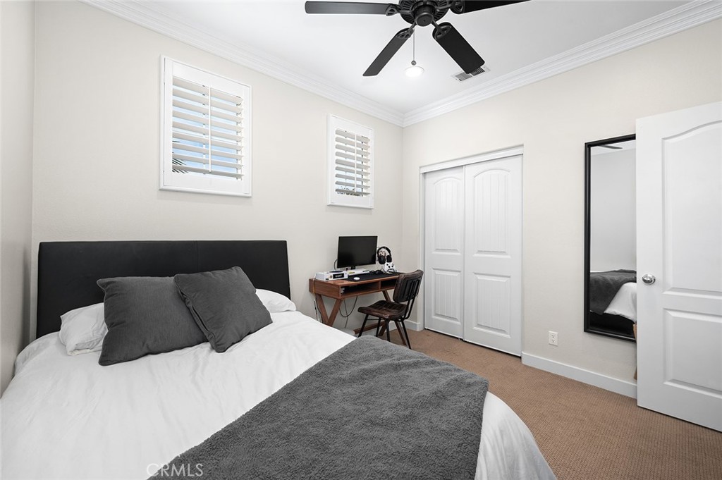 9 Baudin Circle Ladera Ranch, CA 92694 - Photo 29 of 48 a bedroom with a bed and a chandelier