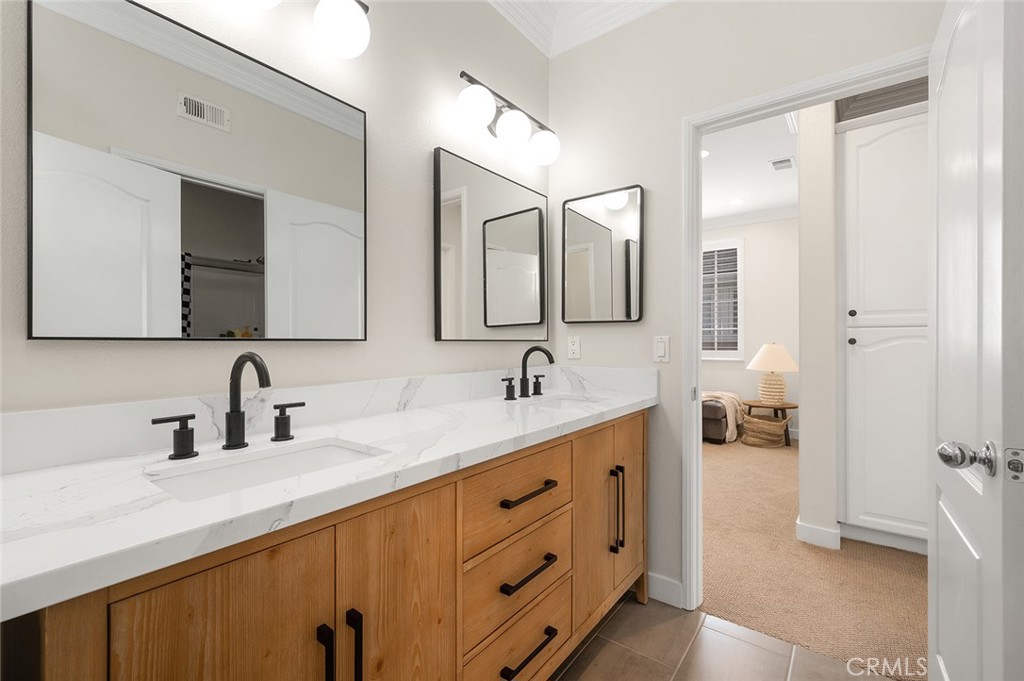 9 Baudin Circle Ladera Ranch, CA 92694 - Photo 30 of 48 a bathroom with a double vanity sink double and mirror