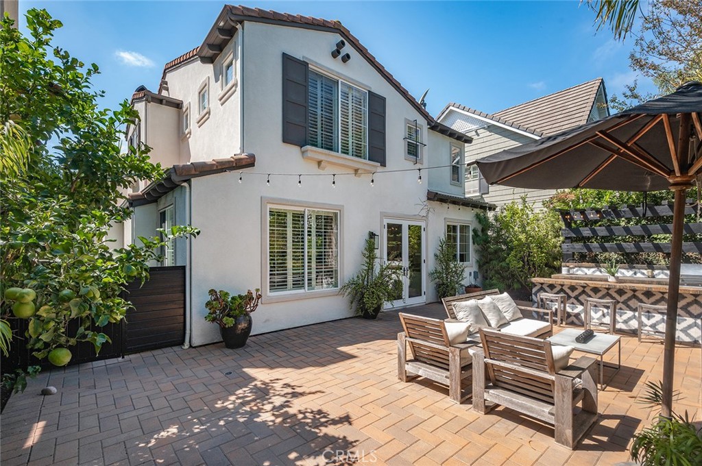 9 Baudin Circle Ladera Ranch, CA 92694 - Photo 35 of 48 a view of a white house with a chairs in patio