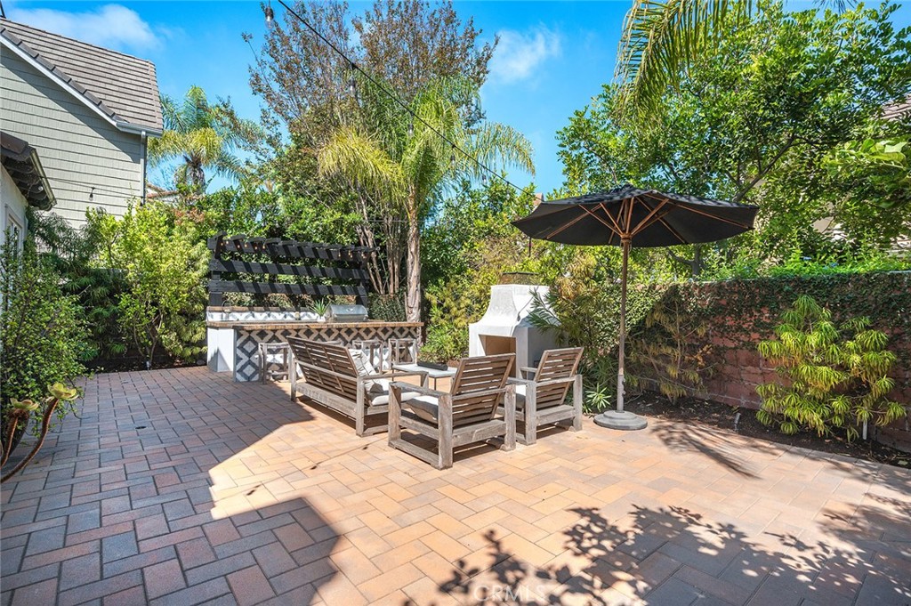 9 Baudin Circle Ladera Ranch, CA 92694 - Photo 36 of 48 a view of a chairs and table under an umbrella