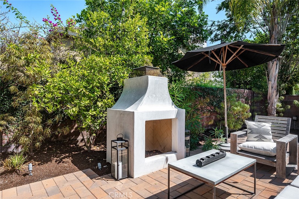 9 Baudin Circle Ladera Ranch, CA 92694 - Photo 38 of 48 a patio with a table and chairs under an umbrella
