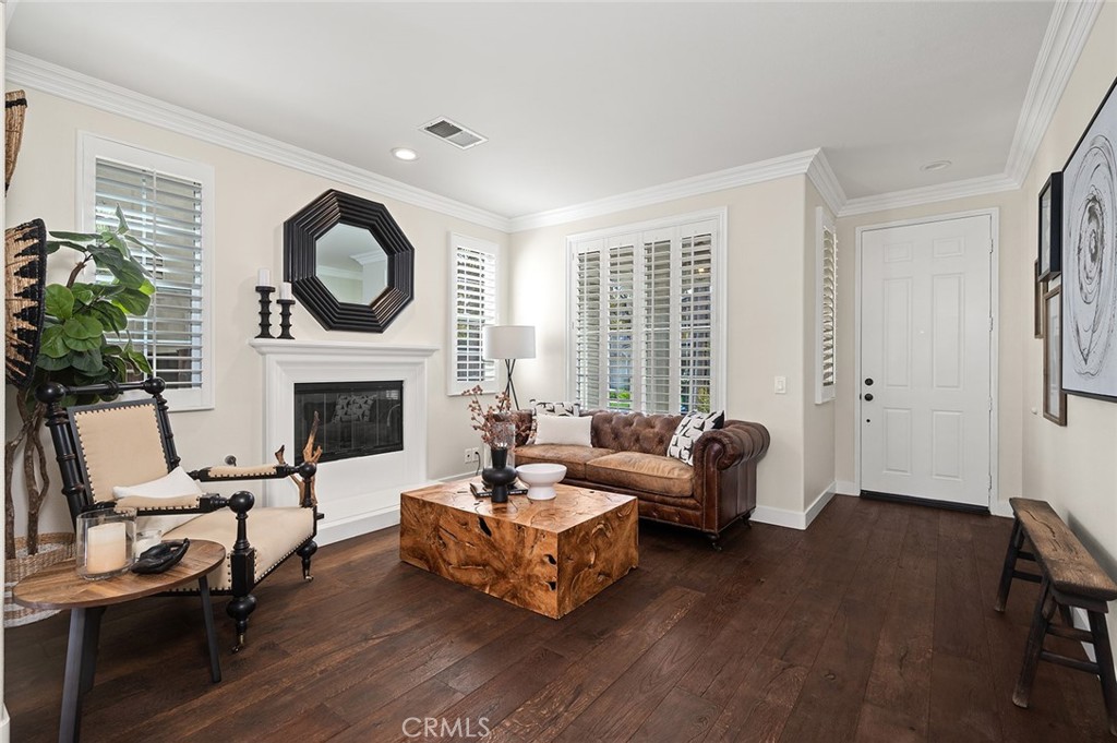 9 Baudin Circle Ladera Ranch, CA 92694 - Photo 5 of 48 a living room with furniture and a fireplace