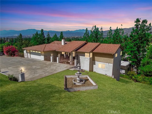 a aerial view of a house with swimming pool garden and patio