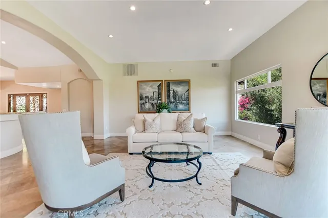 a dining hall with stainless steel appliances kitchen island granite countertop a stove and cabinets