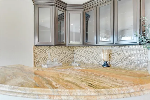 a kitchen with stainless steel appliances granite countertop a sink and a stove