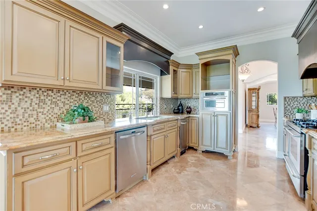 a kitchen with white cabinets and appliances