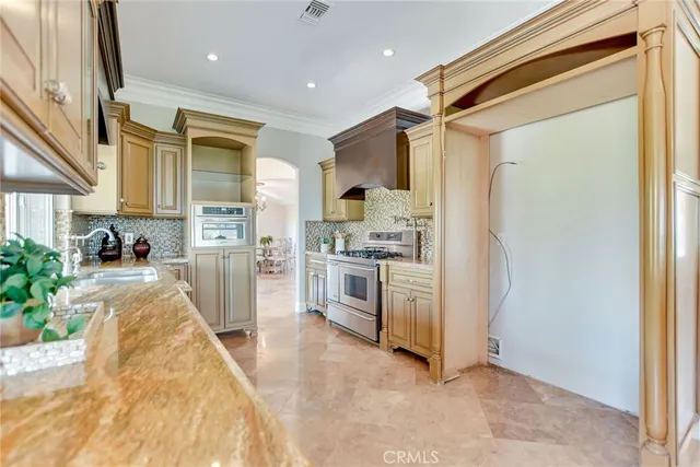 a kitchen with granite countertop a sink and a large window