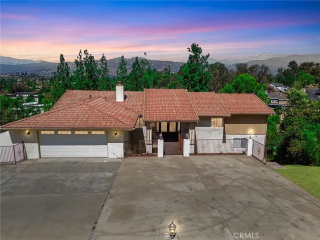an aerial view of a house with a yard table and chairs