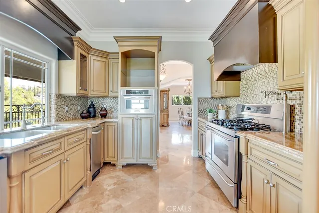 a large kitchen with stainless steel appliances granite countertop a stove and a sink