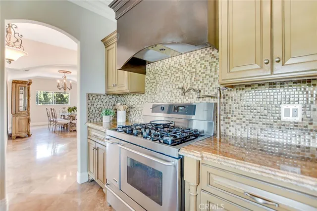 a view of a dining room with furniture a chandelier and wooden floor