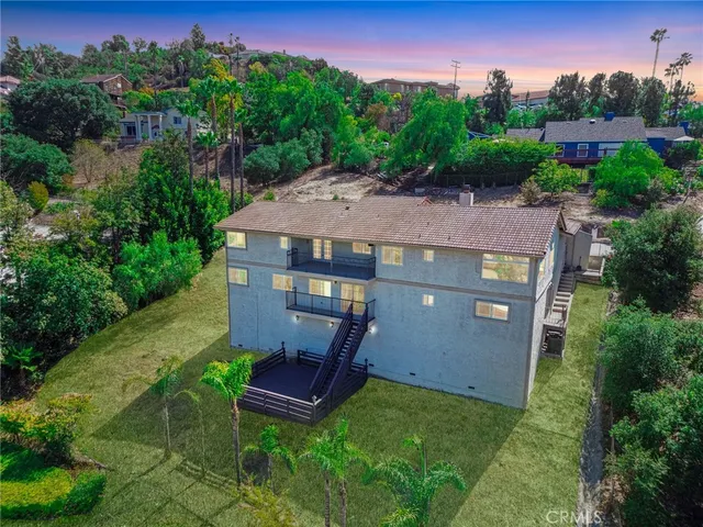 a picture of a house with a yard and potted plants