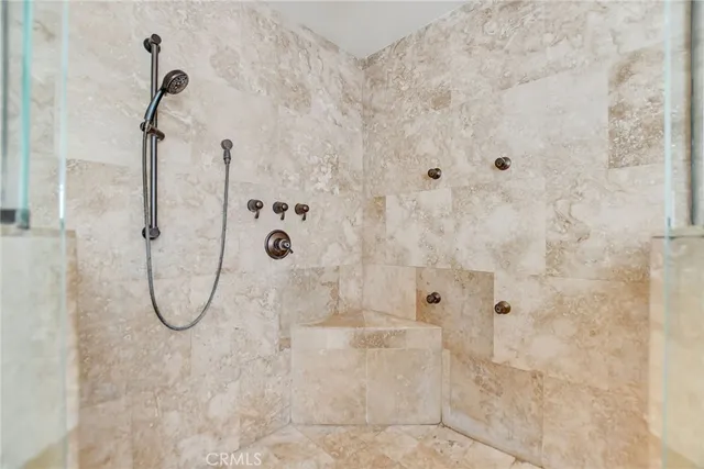a bathroom with a double vanity sink mirror and shower