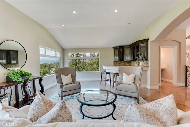 a living room with furniture a rug and a table