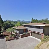 a view of a terrace with a garden and bench