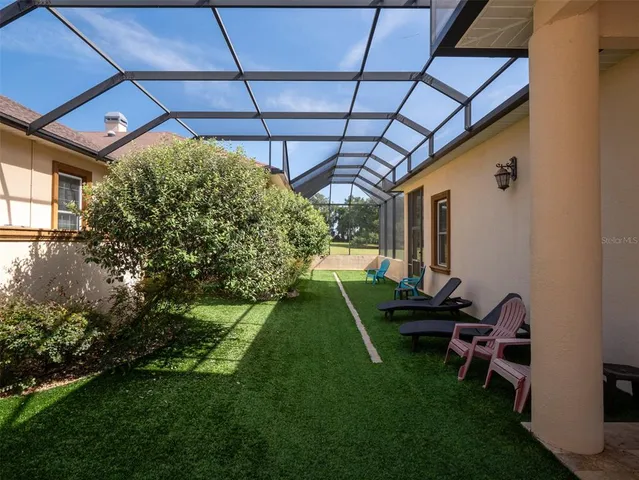 a backyard of a house with table and chairs