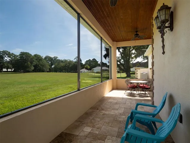 a aerial view of a house with a yard table and chairs