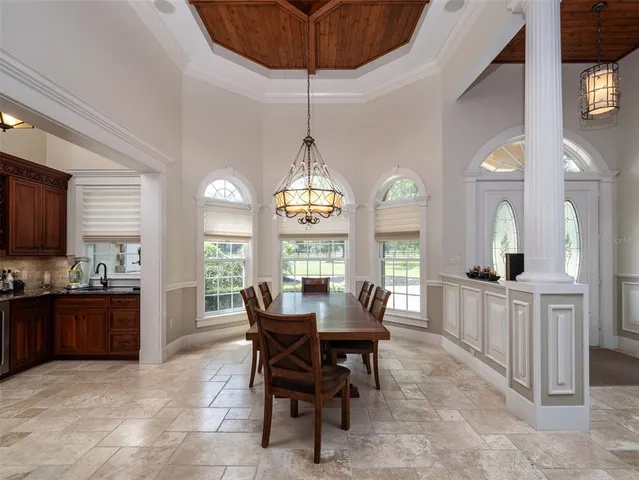 a view of a dining room with furniture and window
