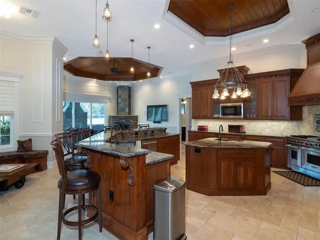 a kitchen with stainless steel appliances granite countertop a stove and a refrigerator