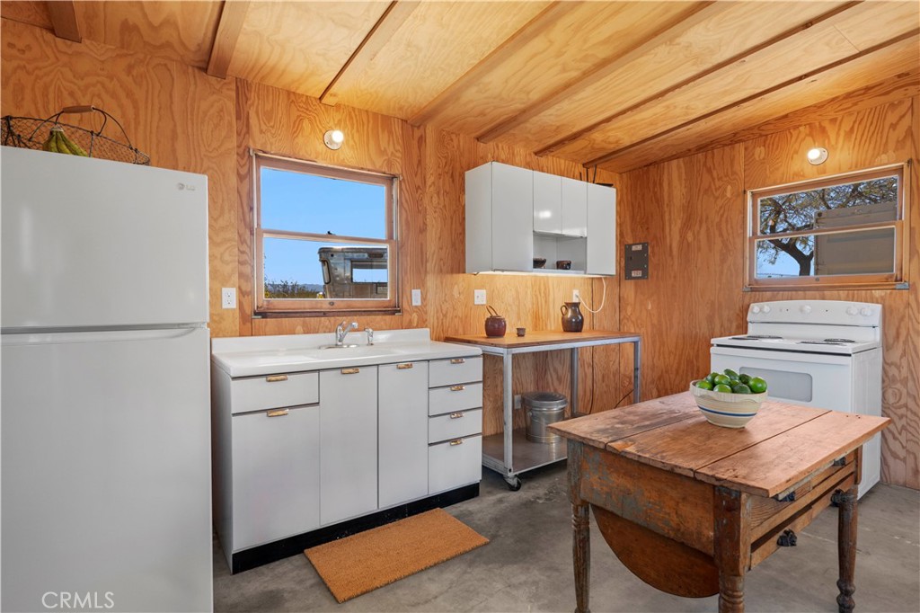 1356 Enchanted Road Joshua Tree, CA 92252 - Photo 12 of 47 a kitchen that has a cabinets and a stove