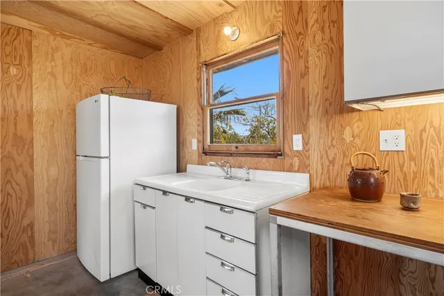 a kitchen with a refrigerator and a sink
