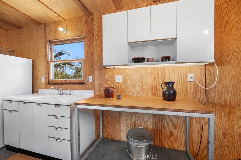 1356 Enchanted Road Joshua Tree, CA 92252 - Photo 14 of 47 a kitchen with a sink stove and cabinets
