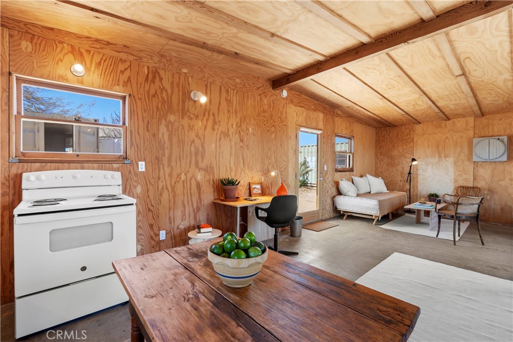 1356 Enchanted Road Joshua Tree, CA 92252 - Photo 15 of 47 a living room with furniture and a potted plant