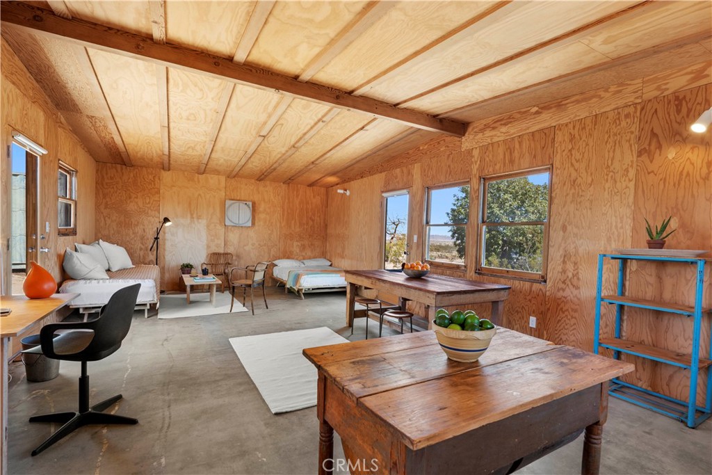 1356 Enchanted Road Joshua Tree, CA 92252 - Photo 16 of 47 a living room with furniture a window and a table
