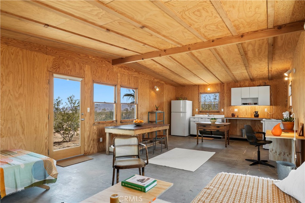 1356 Enchanted Road Joshua Tree, CA 92252 - Photo 19 of 47 a living room with furniture and a table