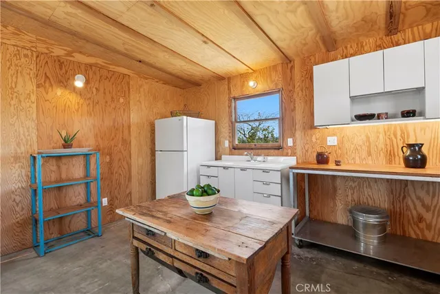 a kitchen that has a table and chair in it