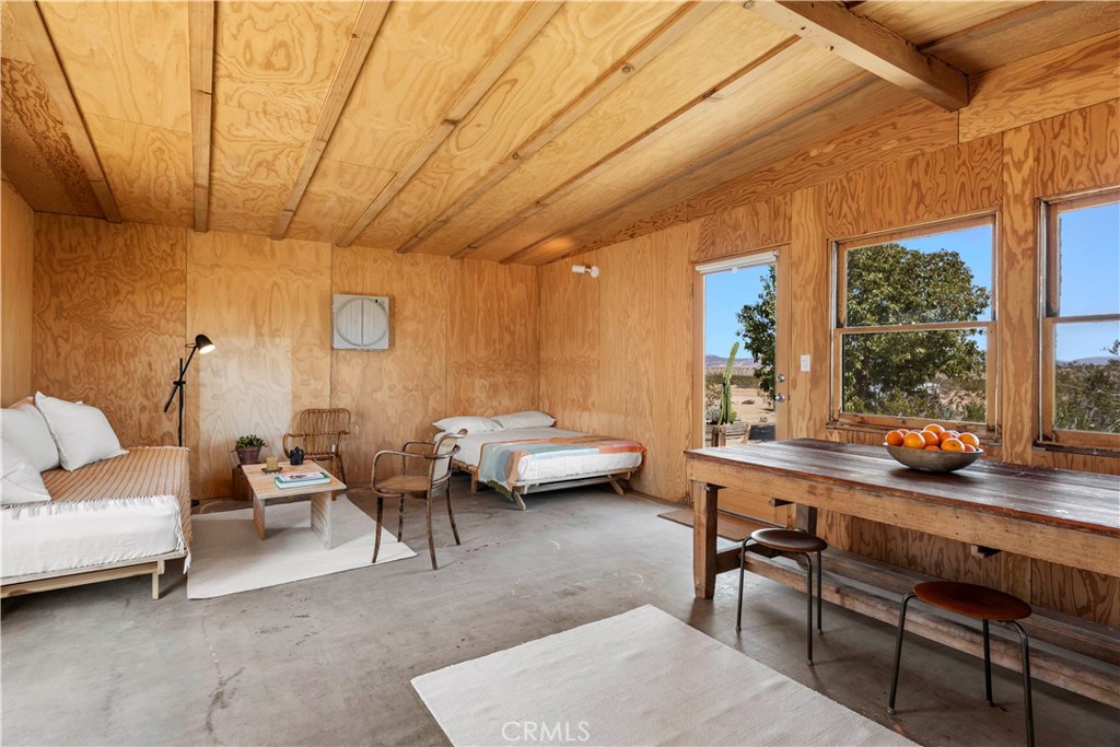 1356 Enchanted Road Joshua Tree, CA 92252 - Photo 21 of 47 a living room with furniture and a table