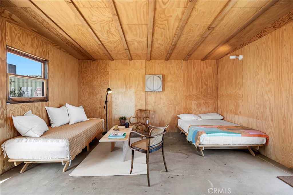 1356 Enchanted Road Joshua Tree, CA 92252 - Photo 22 of 47 a bedroom with furniture and a large window