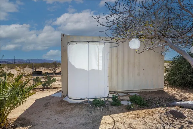 a view of a house with a tree in front of it